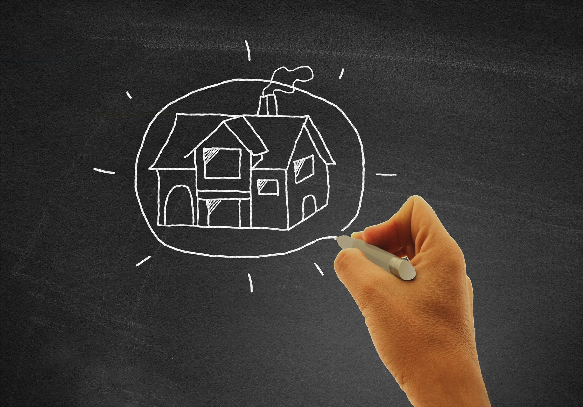 stockvault-hand-drawing-a-house-on-blackboard-real-estate-and-housing-concept178132